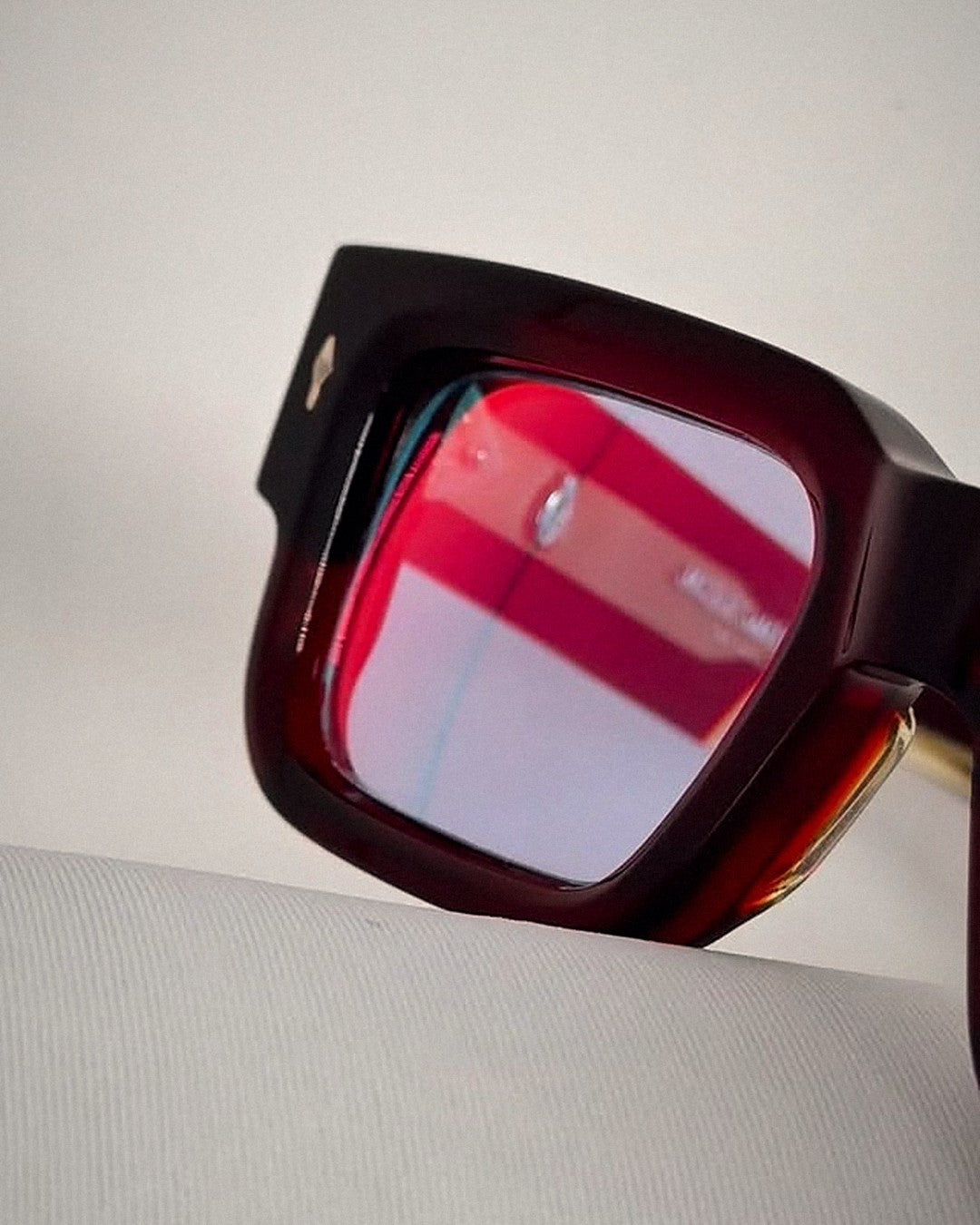Burgundy acetate frame with a custom red lens tint by That Glasses Guy